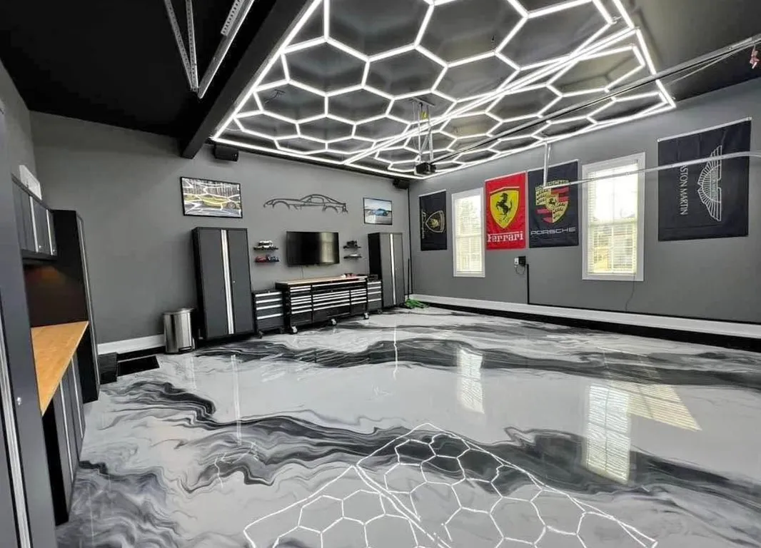 Custom hexagon LED ceiling install in a luxury garage with epoxy floor