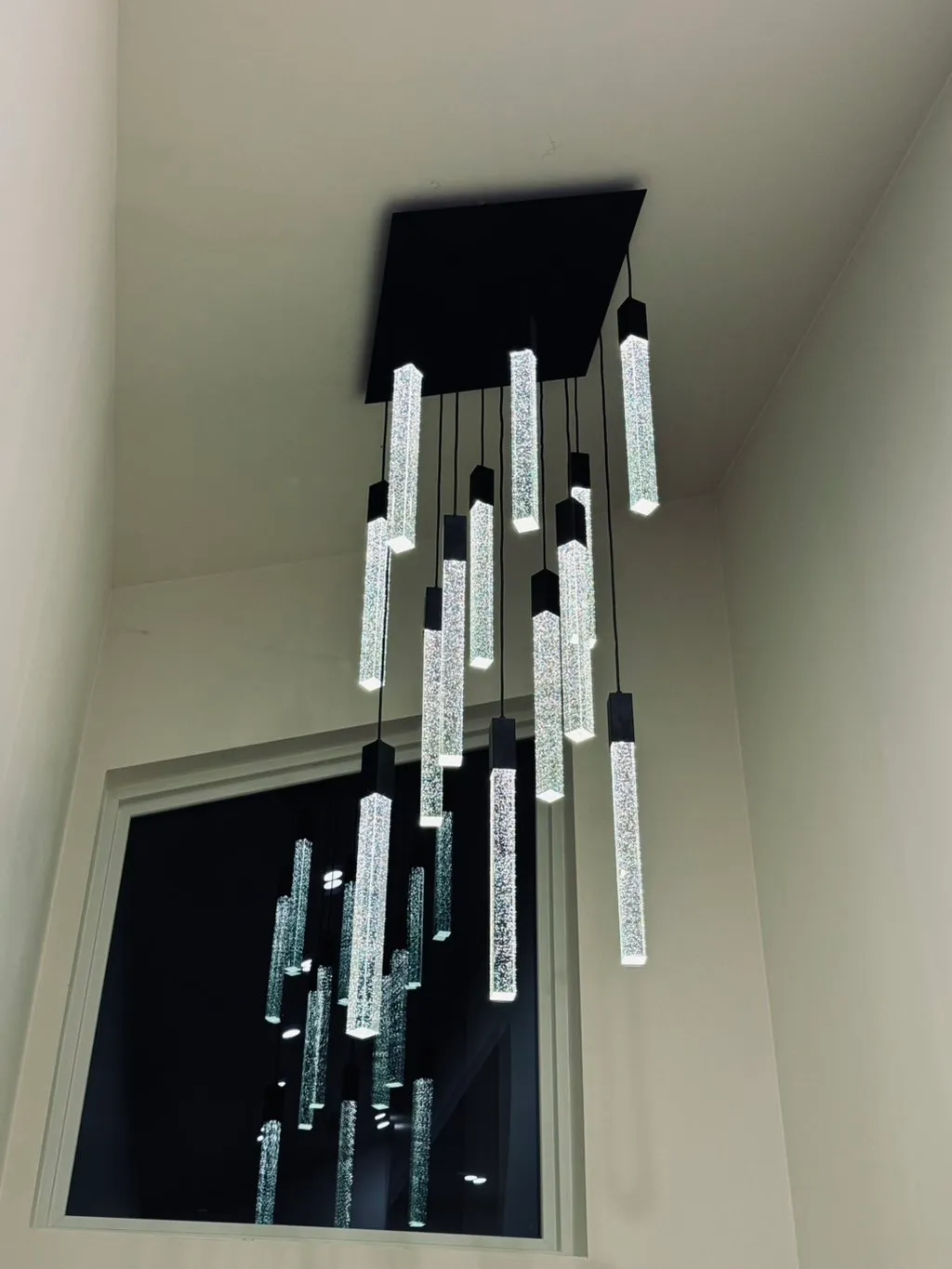 Cascading crystal pendant chandelier in a two-story foyer