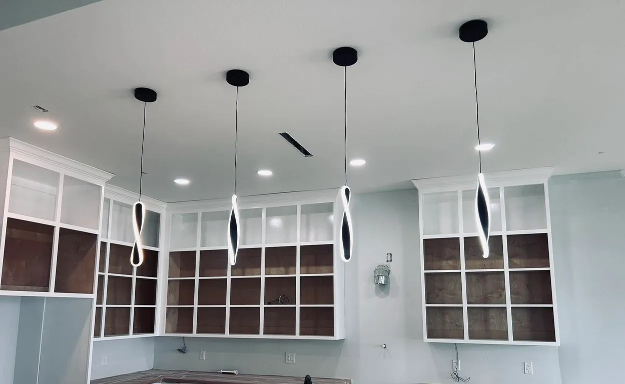 Modern sculptural pendant lights over a custom kitchen island